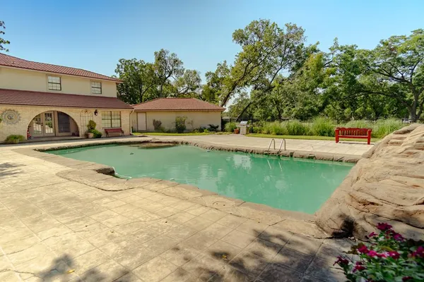 a view of a swimming pool with a patio