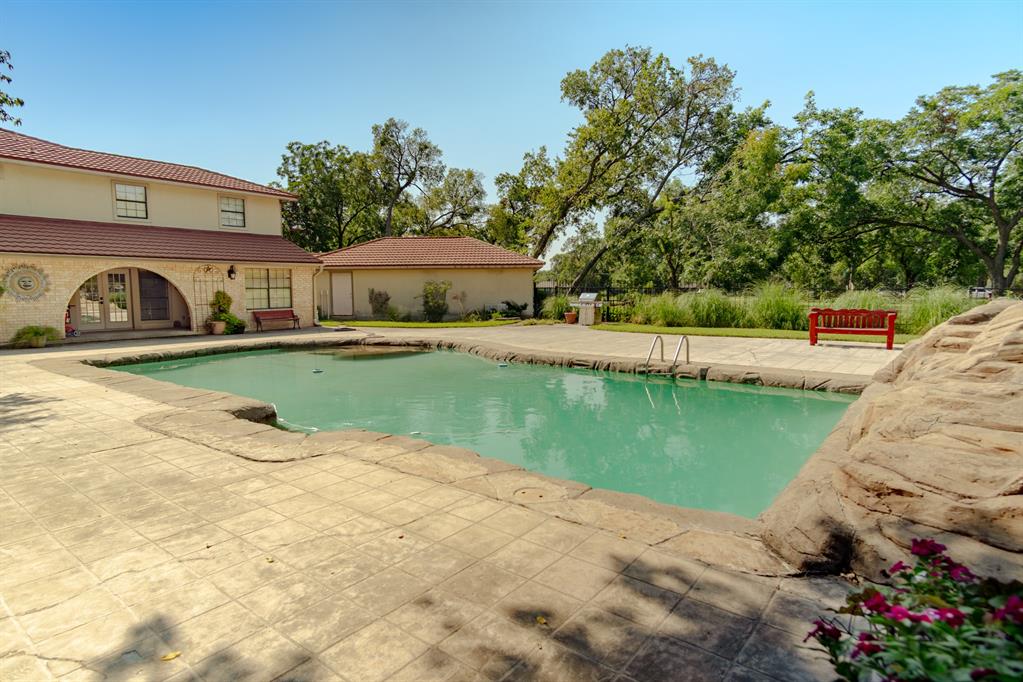 408 Rainey Street Bonham, TX 75418 - Photo 18 of 40 a view of a swimming pool with a patio