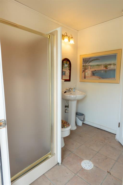 408 Rainey Street Bonham, TX 75418 - Photo 20 of 40 a view of a bathroom with a sink and mirror