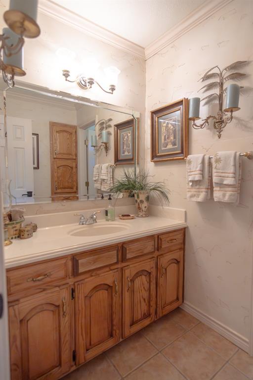 408 Rainey Street Bonham, TX 75418 - Photo 26 of 40 a bathroom with a sink and a mirror