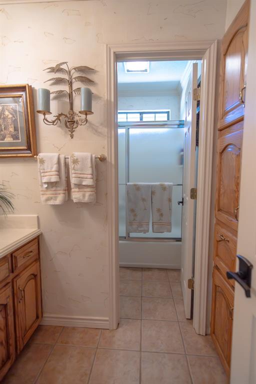 408 Rainey Street Bonham, TX 75418 - Photo 27 of 40 a bathroom with a granite countertop sink and a mirror