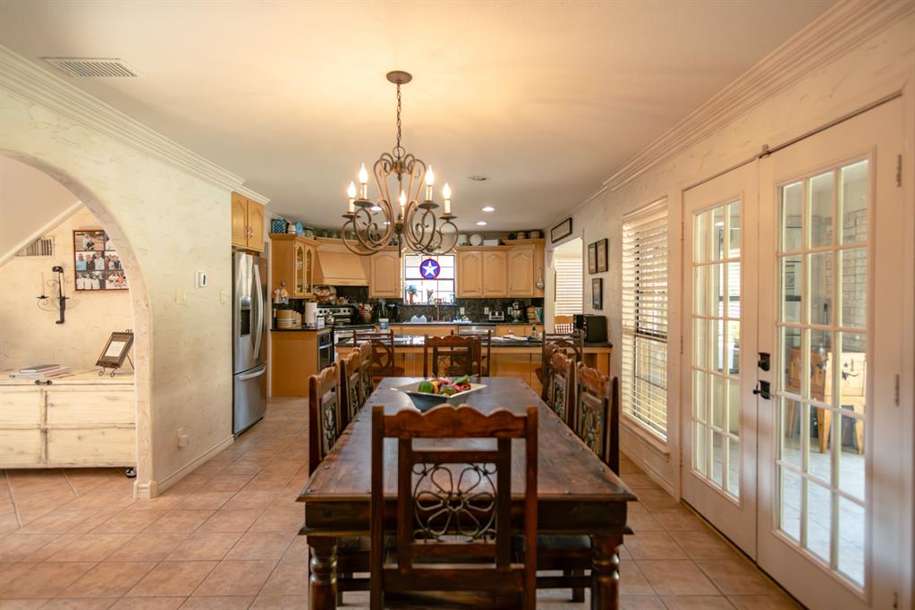 408 Rainey Street Bonham, TX 75418 - Photo 10 of 40 a view of a dining room with furniture and chandelier