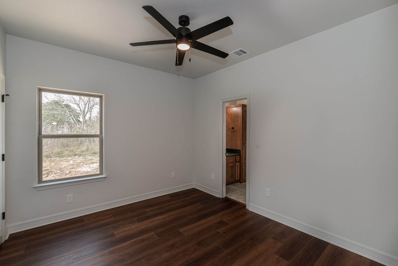 7820 Tolivar Road Beaumont, TX 77713 - Photo 16 of 47 a view of an empty room with wooden floor and a window