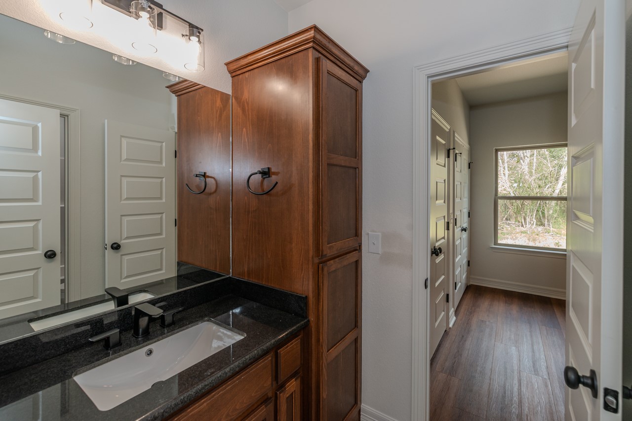7820 Tolivar Road Beaumont, TX 77713 - Photo 19 of 47 a bathroom with a sink a mirror and a shower