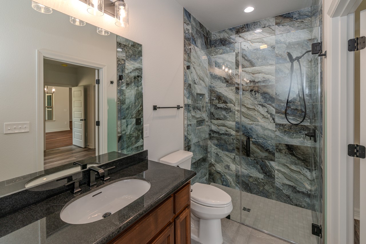 7820 Tolivar Road Beaumont, TX 77713 - Photo 24 of 47 a bathroom with a double vanity sink toilet and shower