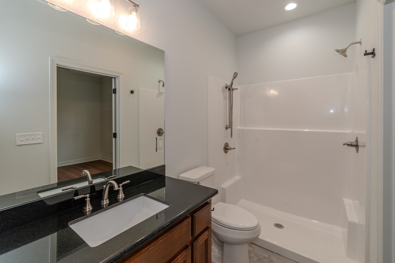 7820 Tolivar Road Beaumont, TX 77713 - Photo 26 of 47 a bathroom with a sink a toilet a mirror and shower
