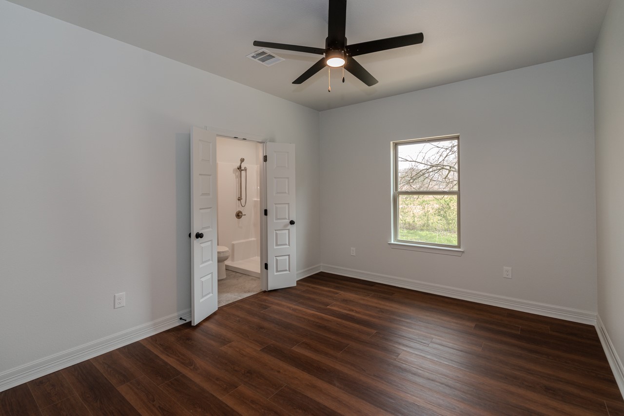 7820 Tolivar Road Beaumont, TX 77713 - Photo 29 of 47 wooden floor in an empty room with a window
