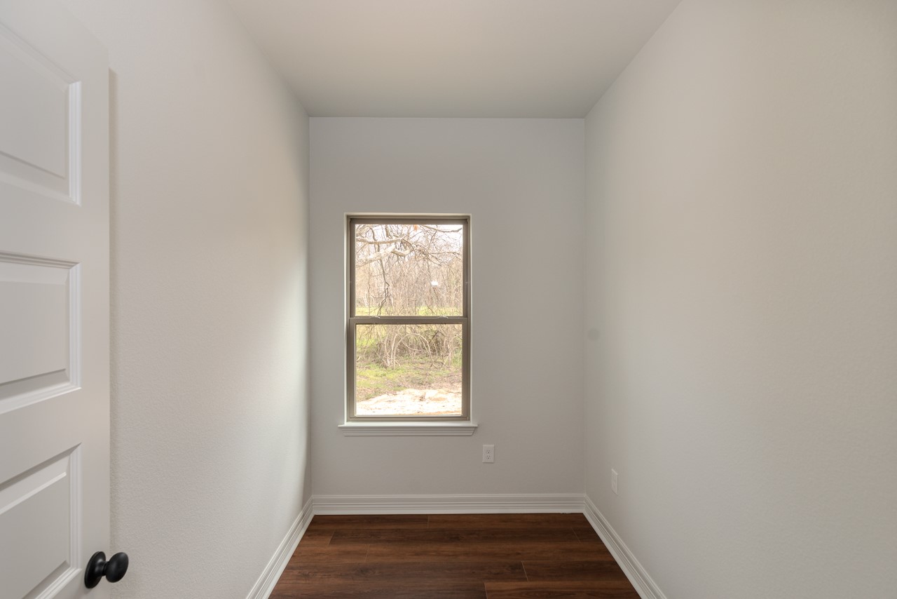 7820 Tolivar Road Beaumont, TX 77713 - Photo 30 of 47 an empty room with wooden floor and windows