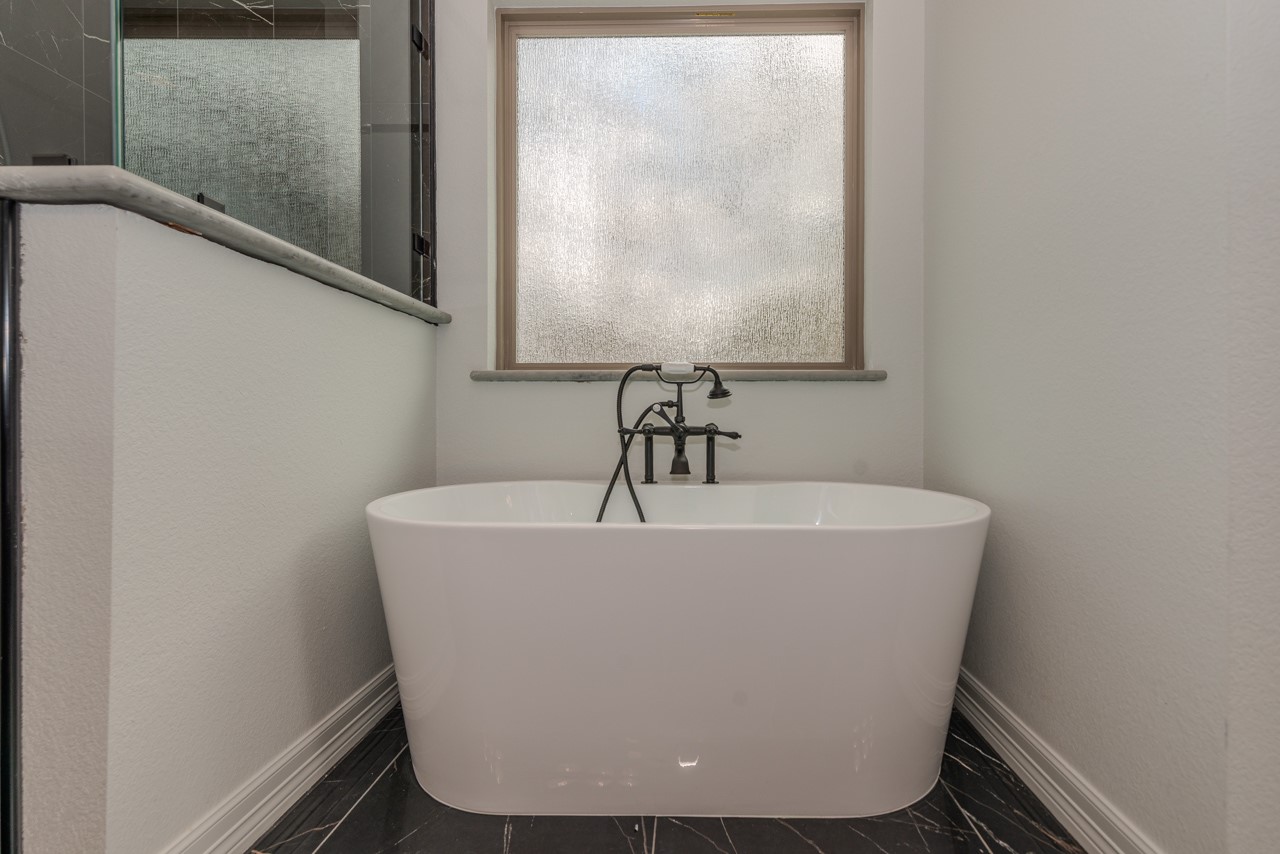 7820 Tolivar Road Beaumont, TX 77713 - Photo 36 of 47 a white tub sitting in a bathroom
