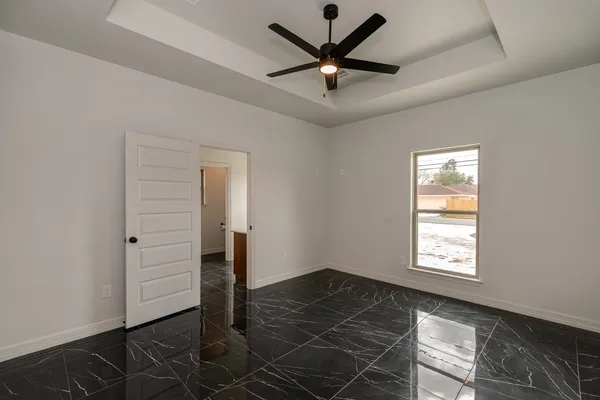 an empty room with closet and windows