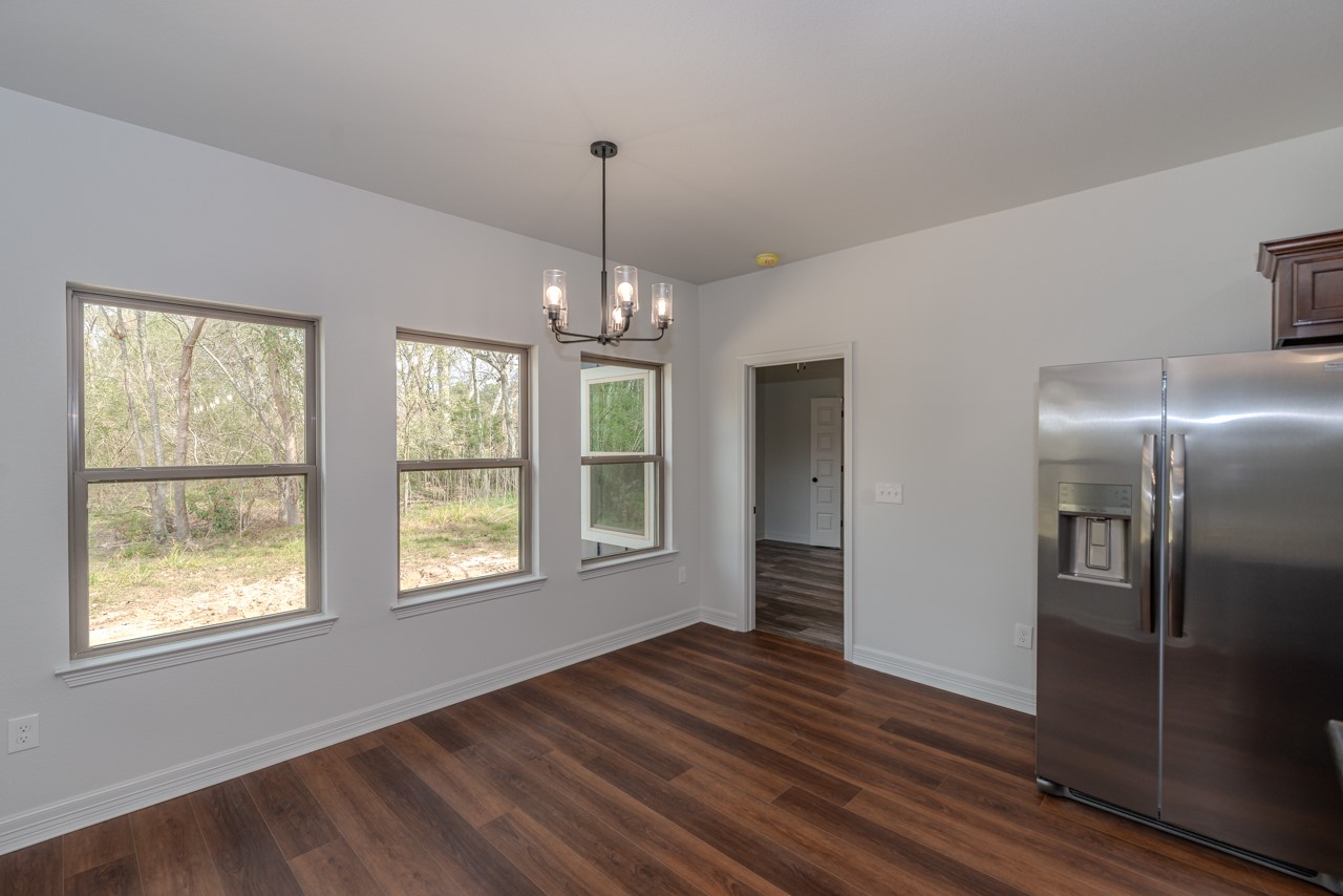 7820 Tolivar Road Beaumont, TX 77713 - Photo 43 of 47 a view of an empty room with wooden floor and a window