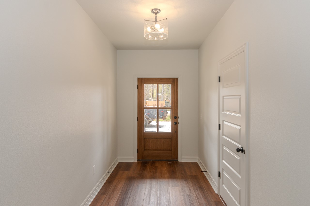 7820 Tolivar Road Beaumont, TX 77713 - Photo 5 of 47 a view of an empty room with wooden floor and a window