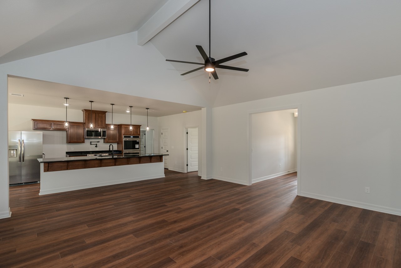 7820 Tolivar Road Beaumont, TX 77713 - Photo 6 of 47 a kitchen with stainless steel appliances kitchen island wooden floors and view living room