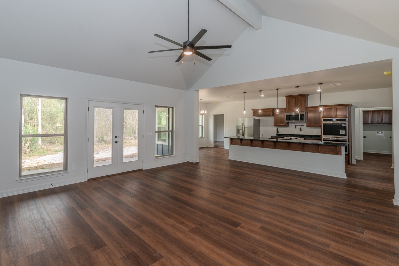 7820 Tolivar Road Beaumont, TX 77713 - Photo 7 of 47 a view of a kitchen with a stove cabinets and wooden floor