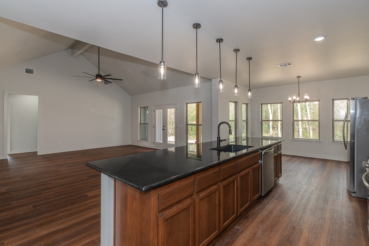 7820 Tolivar Road Beaumont, TX 77713 - Photo 9 of 47 a kitchen with kitchen island a sink appliances and wooden floor