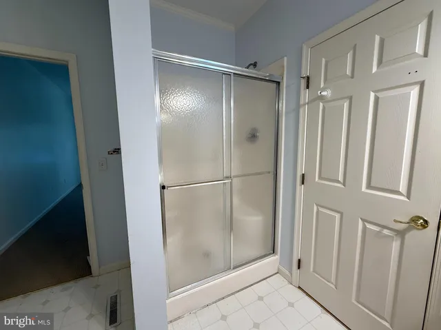 a bathroom with a glass shower door