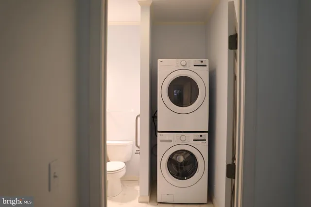 a view of a hallway with a washer and dryer