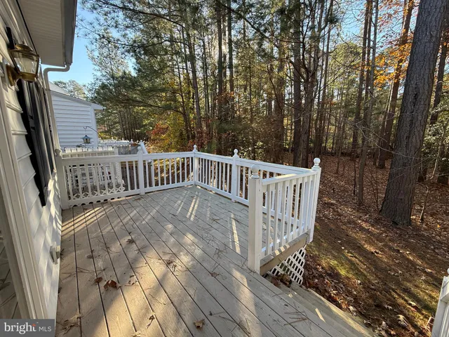 a view of deck with wooden floor and fence