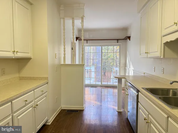 a kitchen with a sink a stove and cabinets
