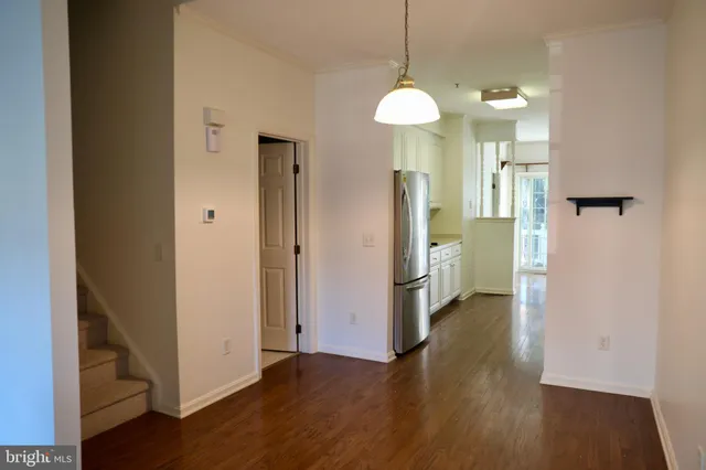 a view of a kitchen from a hallway