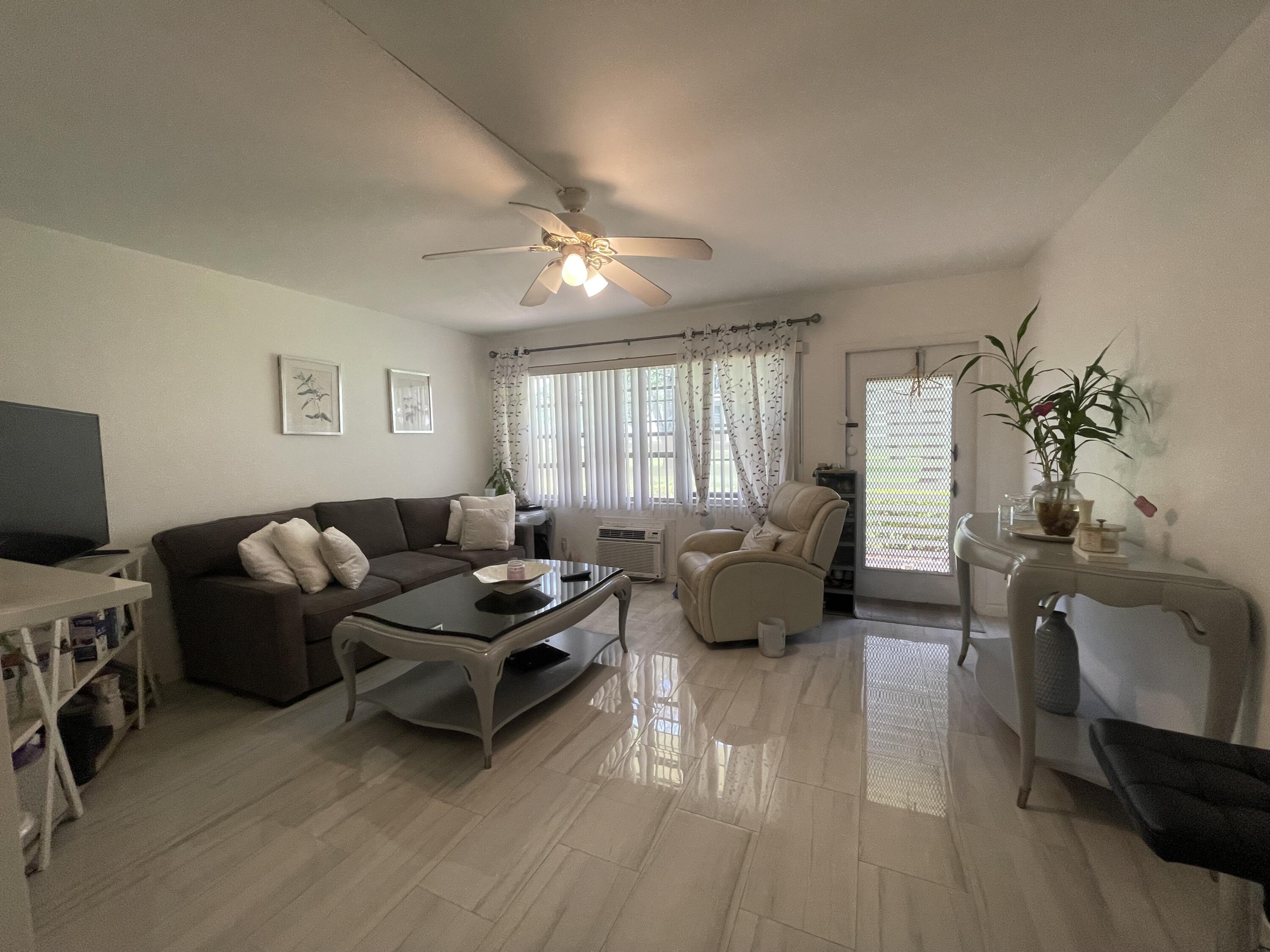 49 Mansfield B Boca Raton, FL 33434 - Photo 23 of 31 a living room with furniture and a flat screen tv