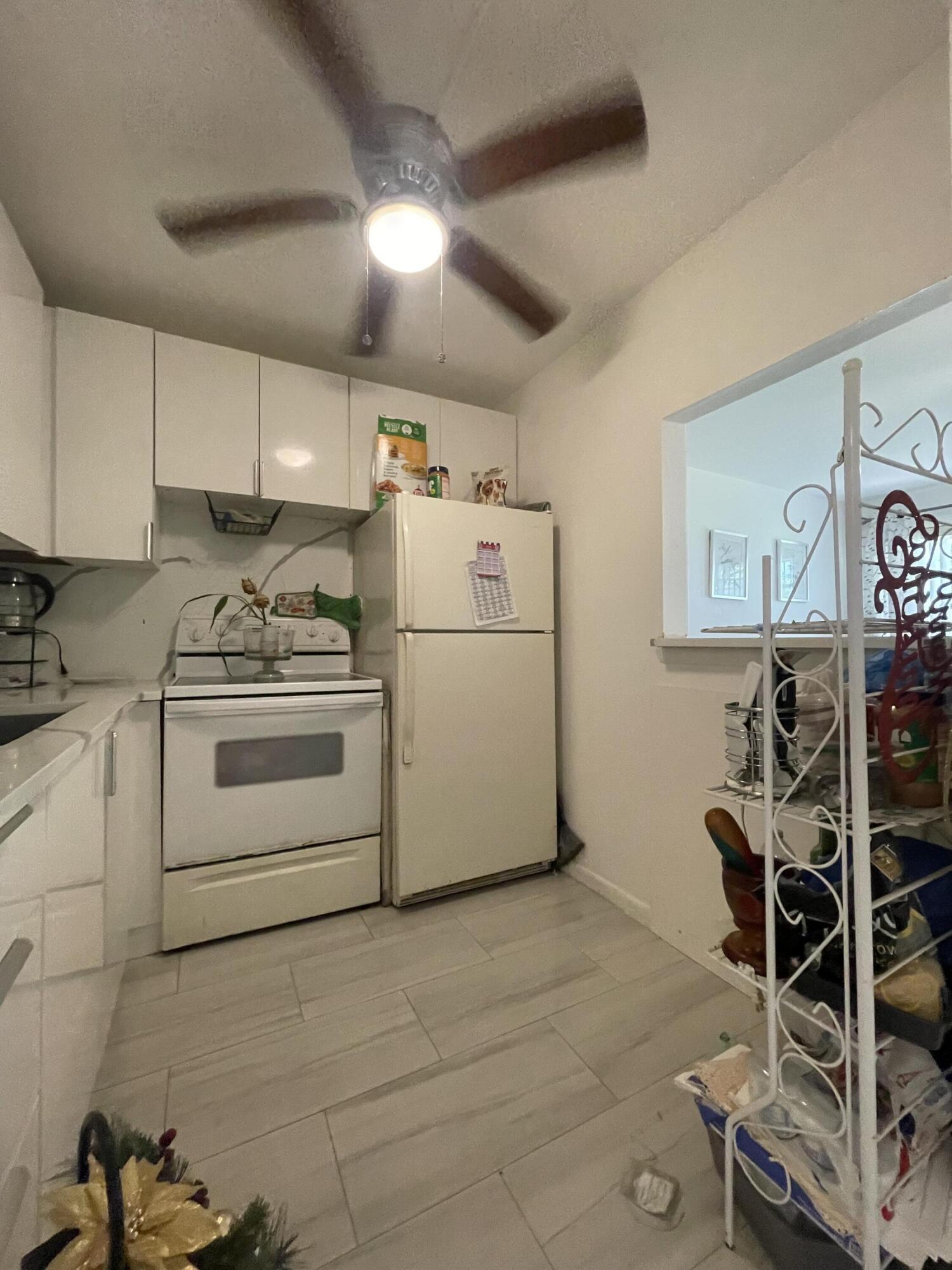 49 Mansfield B Boca Raton, FL 33434 - Photo 8 of 31 a white refrigerator freezer sitting inside of a kitchen