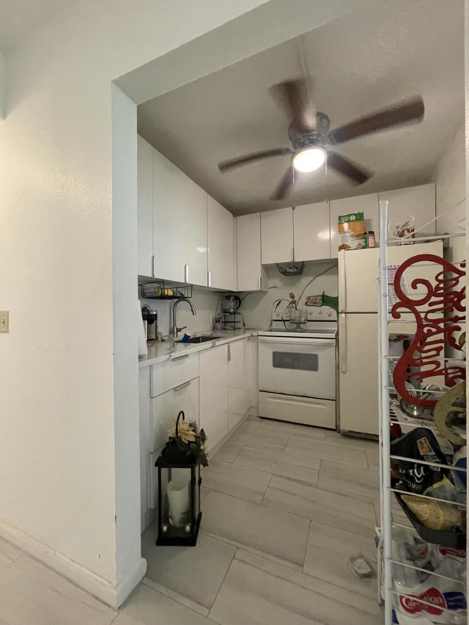 49 Mansfield B Boca Raton, FL 33434 - Photo 9 of 31 a kitchen with stainless steel appliances a refrigerator and a stove