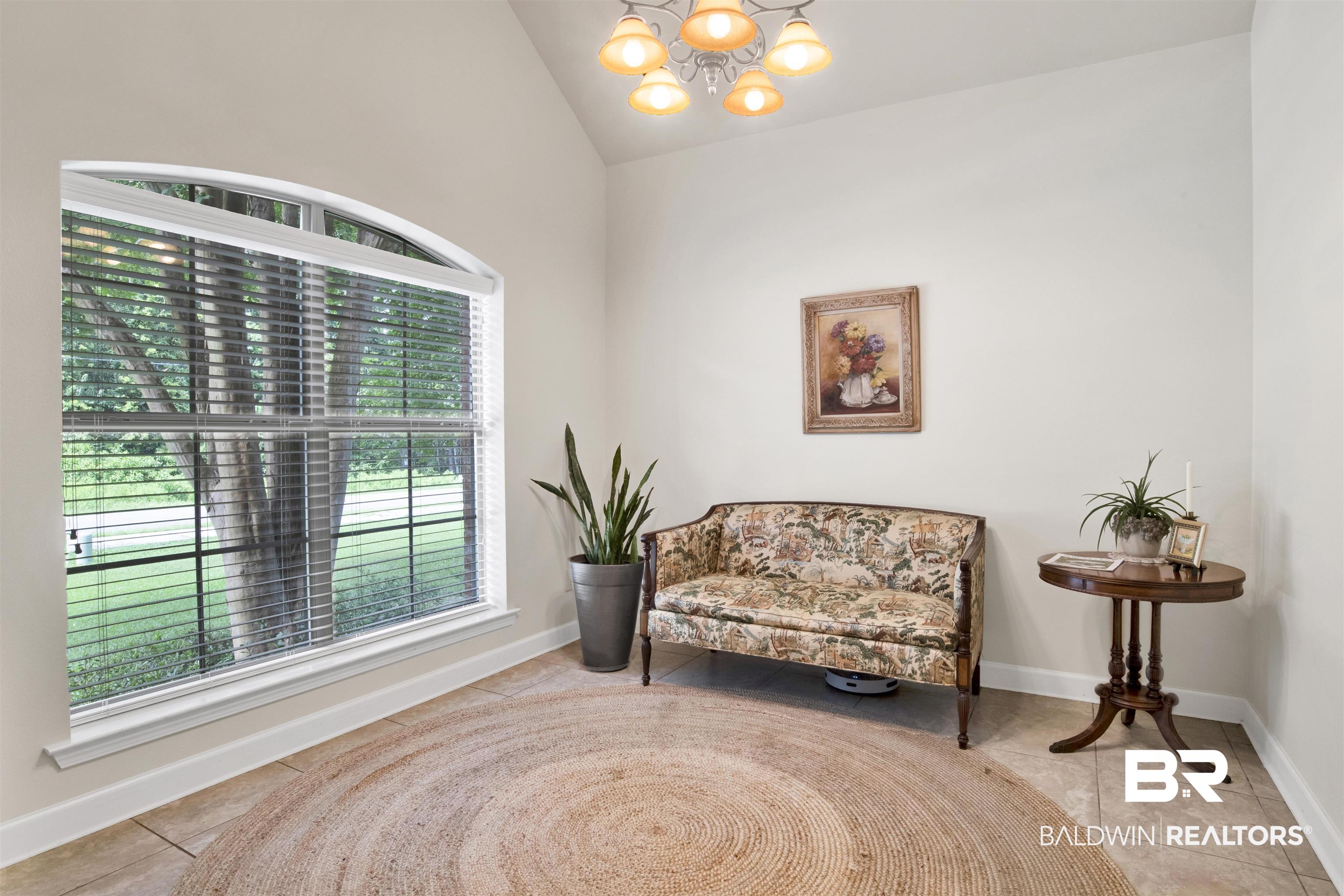 10368 Gayfer Rd Extension Fairhope, AL 36532 - Photo 11 of 43 Arched window with blinds, tile flooring, and vaulted ceiling