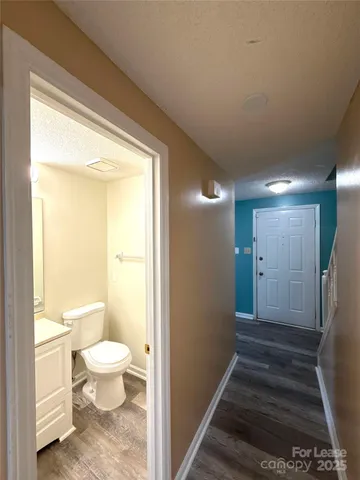 a bathroom with a granite countertop sink a toilet and a shower