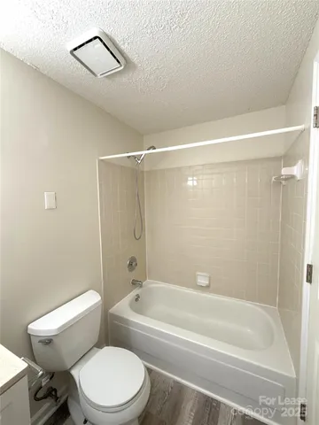 a bathroom with a toilet and a bathtub