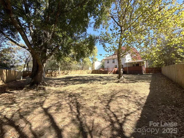 a view of yard covered with snow in front of house