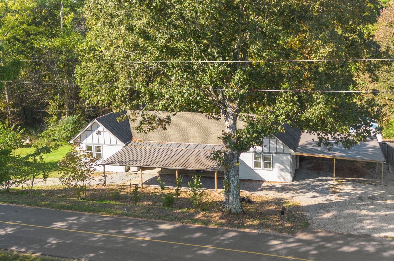 10209 New Hope Road Bon Aqua, TN 37025 - Photo 22 of 27 a front view of a house with a yard