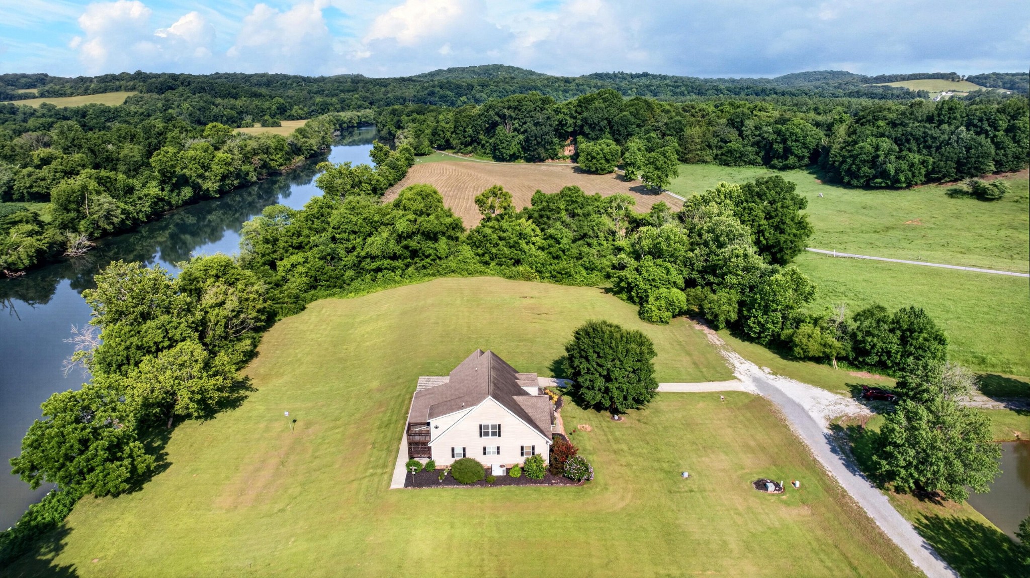 759 Pinhook Road Calhoun, TN 37309 - Photo 63 of 70 an aerial view of a house with a yard and lake view