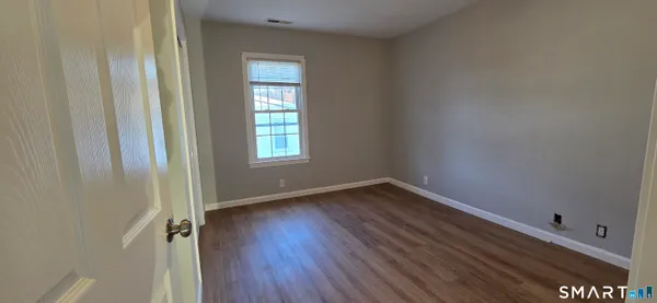 a view of a small space with wooden floor