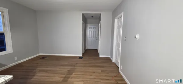 a view of a room with wooden floor