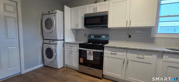 a utility room with sink dryer and washer