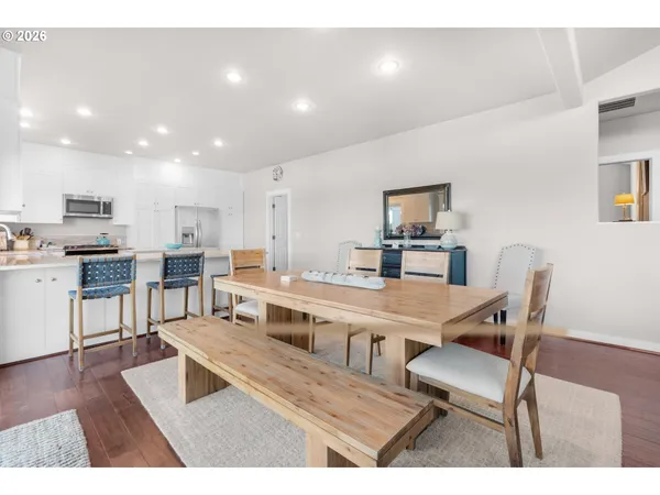 a view of kitchen with cabinets table and chairs