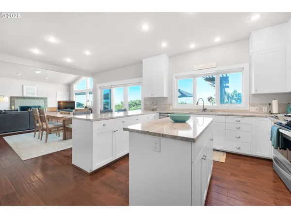 a kitchen with a sink cabinets and wooden floor