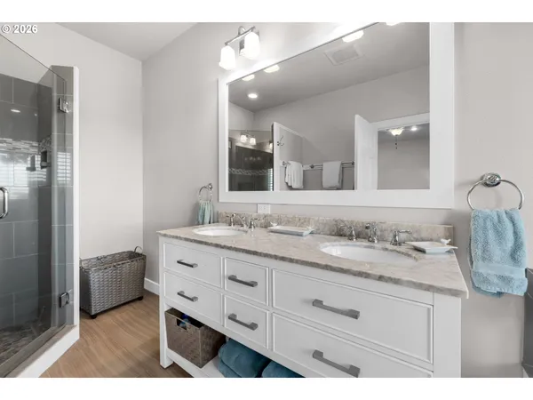 a bathroom with a granite countertop sink double and mirror