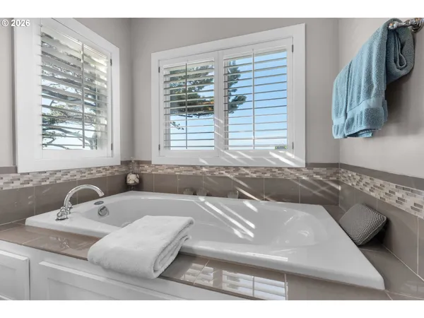 a bath tub sitting in a bathroom next to a window