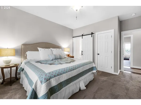 a bedroom with a bed and a lamp