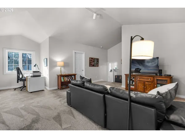 a living room with furniture and a mirror
