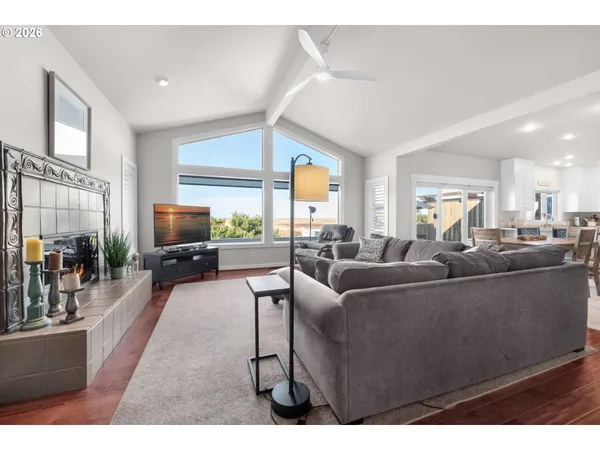 a living room with furniture a large window and a flat screen tv
