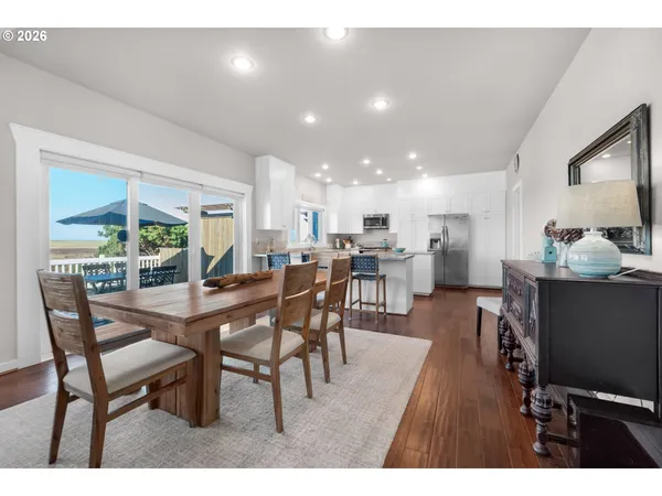 a dining room with furniture and a floor to ceiling window