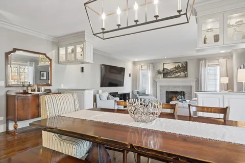 a kitchen with stainless steel appliances granite countertop a stove a sink and a refrigerator with wooden floor