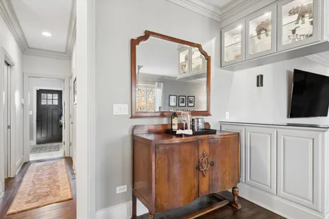 a room with lots of wooden furniture and potted plants