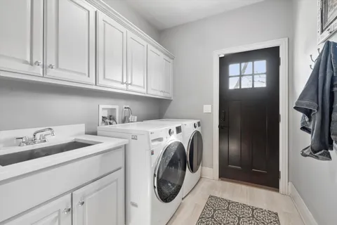 a living room with furniture a fireplace and a chandelier