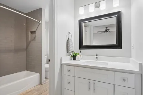 a spacious bedroom with a bed couch and window