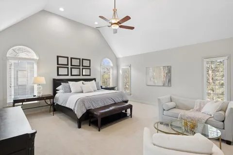 a spacious bedroom with a bed and dresser