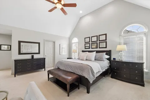 a spacious bathroom with a tub sink and mirror